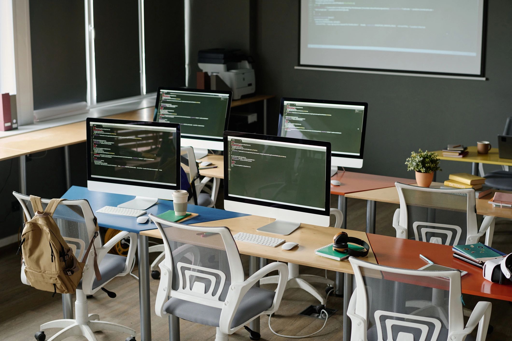 Modern computer lab with code on screens